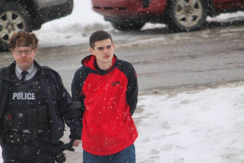 Ian Tallack is seen being led into Stephenville Provincial Court on Tuesday by a member of the Bay St. George RCMP.