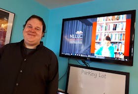 Bradley Crann of Rogue Freelance poses with the new Newfoundland and Labrador Laubach Literacy Council logo and brand products.