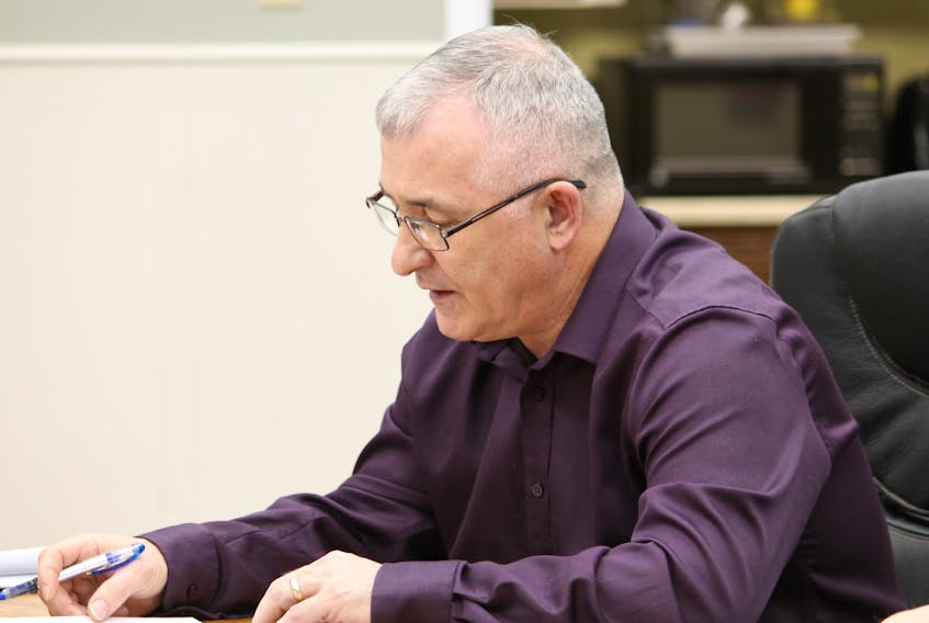 Mark Felix is seen going through the finance minutes at Thursday's meeting of the Stephenville town council.