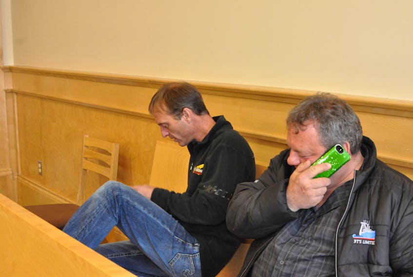 Tony Young, left, and Todd Young are seen in provincial court in Corner Brook on Tuesday. The brothers were there in anticipation of hearing a verdict on a number of charges related to allegations of illegal reporting of herring catches at their 3Ts fish plant in Woody Point in the fall of 2010.
