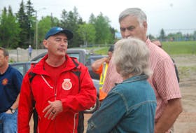 Chief Petty Officer 2nd Class John McCarthy, a member of the Run the Rock crew, is seen here chatting with Winston and Dorothy Childs during the reception that saw young and old alike show up to say hello and wish the runners all the best for the remainder of the journey across the province.