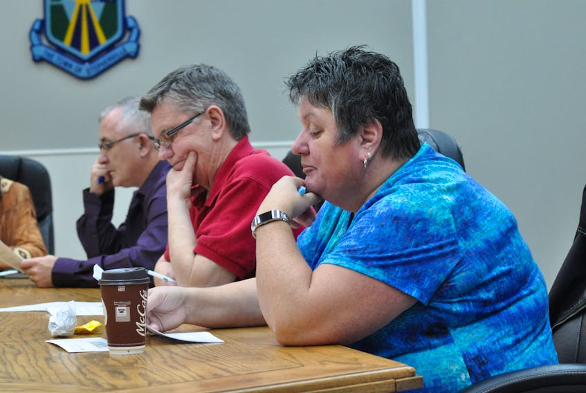 Deputy Mayor Susan Fowlow, chair of the Stephenville town council's planning and traffic committee, reads out requests for permits and outline planning permission at the regular general meeting on Thursday. Listening in, from left, are Coun. Mark Felix and Coun. Mike Tobin.
