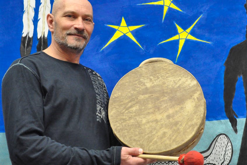 Indigenous artist Scott Butt poses for a photo with his drum at the People of the Dawn Friendship Centre in Stephenville, where he will be participating in an Indigenous Arts and Crafts Showcase on Saturday.