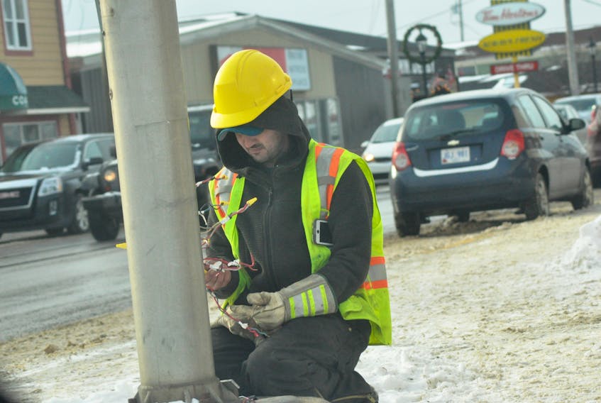An unidentified electrician with EFCO Enterprises works on some wiring in a traffic light pole Tuesday afternoon in front of Subway Restaurant on Main Street in Stephenville. The traffic lights at the intersection of Main and Queen streets in Stephenville were not functioning due to what was believed to be a short in the wiring.
