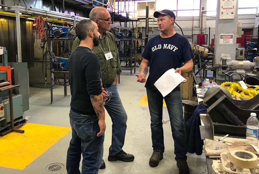 Part of this week's visit to College of the North Atlantic campuses in Port aux Basques, Bay St. George and Corner Brook was a tour of the shop at the Martin Gallant Building. Here from left: Brian Burton and Peter Cappuccio of NOVA Career Centre in Chateauguay, QC, talk with David Hardy, welder instructor at Port aux Basques campus.