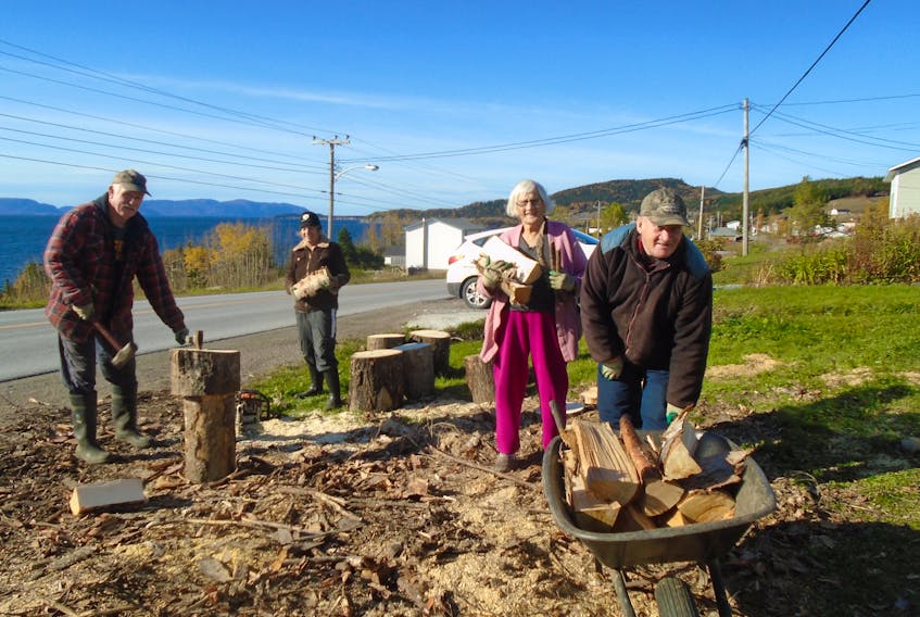 The weather was good enough for a wood chop this week, offering cultural appreciation for yet another chance to get some backup heating fuel, even some Christmas craft pieces, put away for winter use. The locally-delivered wood cut into fireplace sticks with the help neighbour Clyde Blanchard (not in photo), this fine family crew of 50-plus folk from McIvers on the Bay of Islands lower north shore stood inspired by the work ethic shown by a dear 89-year-old mentor, Mrs. Hannah Park, who is one of town's oldest citizens. She was happy to have her snap taken helping out her woodchopper son-in-law Pat Gambin and daughter Dolly Park-Gambin load the waiting wheelbarrow for her son, Warren (Bud) Park.
