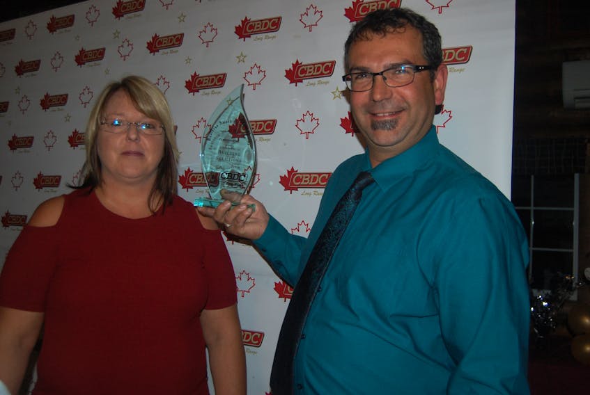 Kim and Doug Benoit of ICR Building Solutions pose for a photo with the CBDC Long Range Business Award of Distinction they received on Wednesday evening.