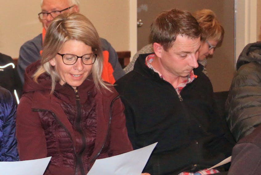 Dawn and Jamie Park owners of Park fitness check out the council meeting agenda as they sat in the gallery at the Oct. 01 council meeting at the town office in Deer Lake. They were surrounded by a number of supporters