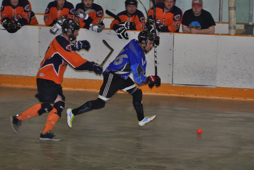 Luxury Limo Rangers' Steve Hobbs looks to pounce on the ball and head towards the offensive zone with Gros Morne Wildlife Museum Gulls' Kerry Shears giving chase during Game 2 of the men's ball hockey league final on Thursday night at the Kinsmen Arena II.