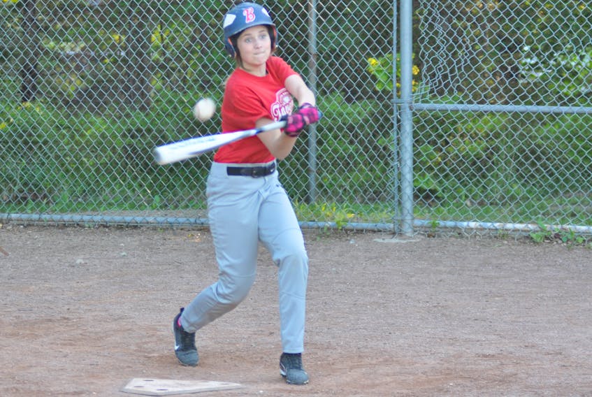Here, Ana White of the Corner Brook Barons U14 girls team makes contact with a pitch during team practice Wednesday evening at Little Jubilee Field.