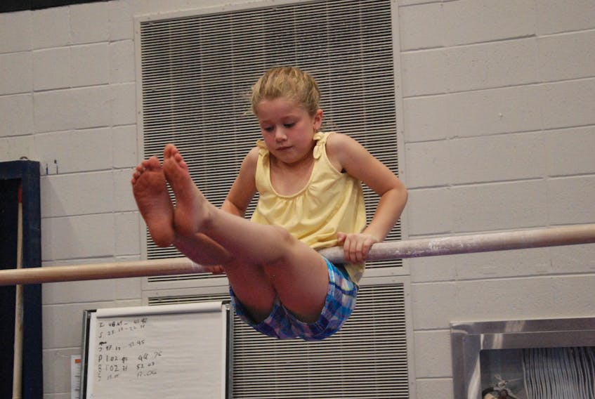 Sydney Rowe, 7, was one of the youngsters who was having fun at the Saltos gym Wednesday afternoon and trying out the different gymnastics apparatus was how she wanted to spend her time.