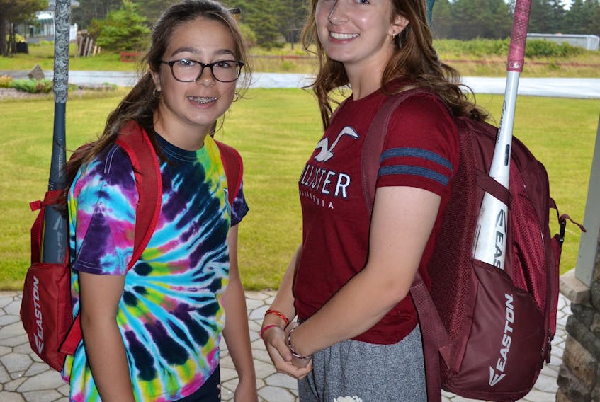 Devaro Chislett, left, and her older sibling Shilo, pose for a photo before travelling to St. John's to play in the 2018 Baseball Atlantic 14U Girls Invitational this weekend in St. John's. Shilo will suit up with the Corner Brook Barons as an overager, while Devaro is playing for Nova Scotia 2 who recruited her to fill a roster player for one of the team's injured members.