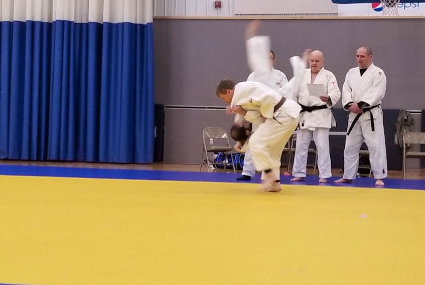Jason Bolton is seen here completing some throws during his black belt upgrade in St. John's over the weekend. He may have taken the long road, 35 years to be exact, but Bolton is a happy camper knowing he achieved a milestone in his judo life.