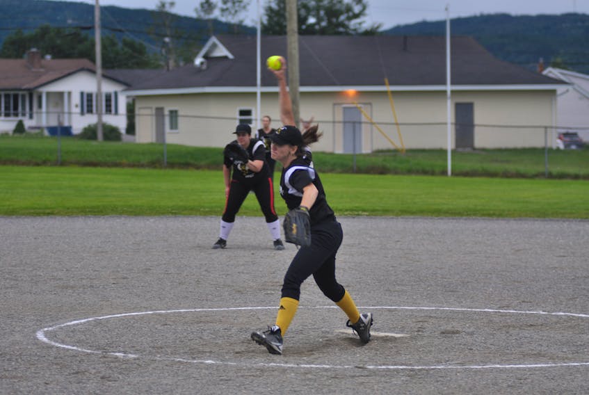 Rapid Power Sports Bees' Lorna Lovell winds up for the pitch during women's softball league play Thursday night at Ambrose O'Reilly Memorial Field.