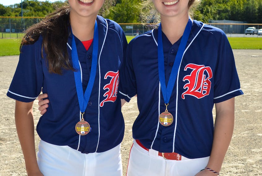 Hannah Legge, left, and Shilo Chislett of the Corner Brook Barons pose for a photo with their medals dangling around their necks after a 2-0 victory over Nova Scotia 2 in the showdown for bronze at the 2018 Baseball Atlantic 14U Girls Championship held in St. John's over the weekend.