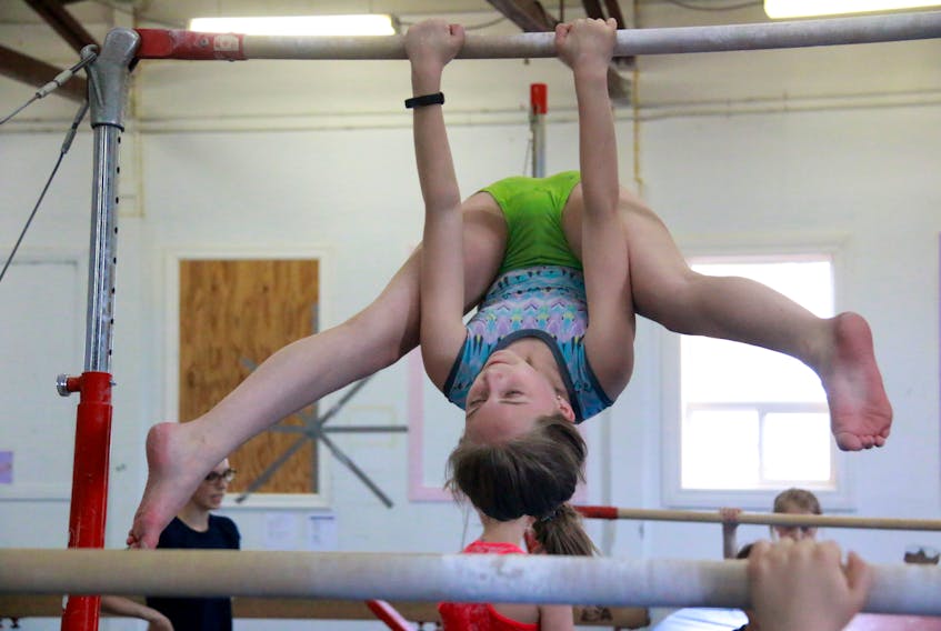 Here, Sara O'Brien practises her routine on bars on Monday.