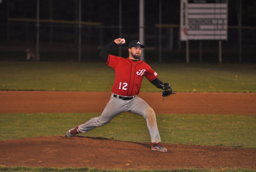 Veitch Wellness Aces' Steve Hynes winds up to deliver a pitch against the West Side Monarchs during Game 6 of the city senior baseball league final Thursday evening at Jubilee Field.