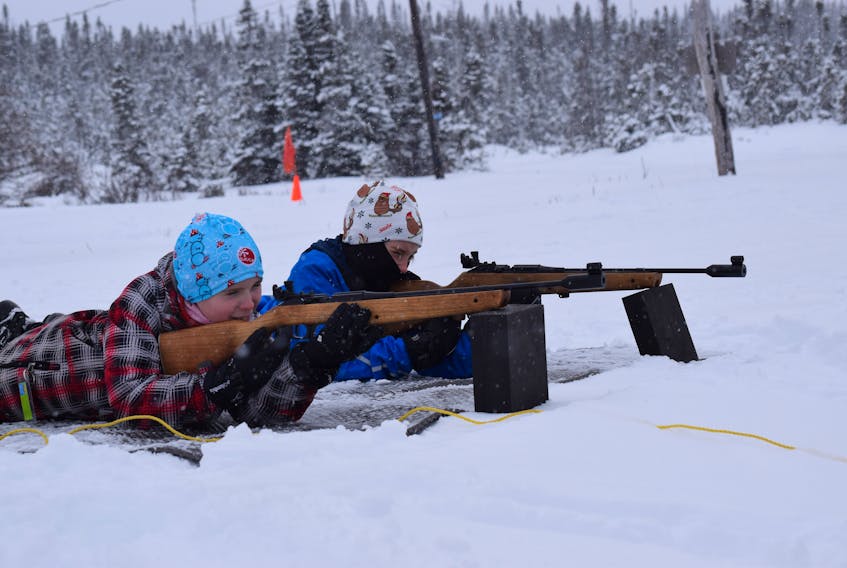 Jakob Hann, left, and Georgia Wiseman get in some practice at the rifle range during a Blow Me Down Biathlon Club’s Bears Program session Saturday afternoon at Blow Me Down Trails in Corner Brook.
