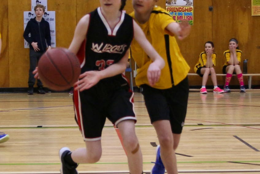 Eastside Elementary’s Brooke Evoy, left, dribbles the ball while C.C. Loughlin’s Georgia Wiseman defends during action from the annual RNCA Grade 6 basketball tournament.