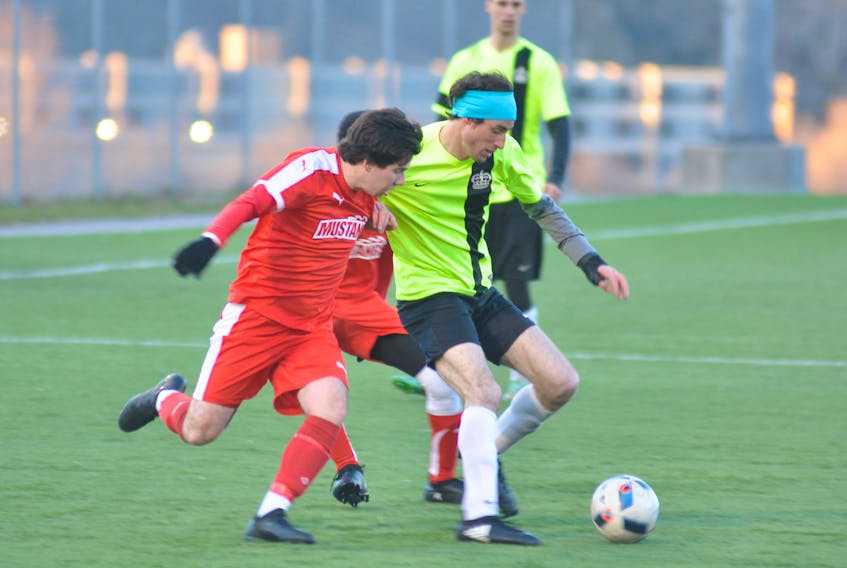 West Side Monarchs' Dane Kawaja, right, and Ford Mustangs' Jacob Westcott battle for control of the ball during opening game action from the annual Corner Brook Men's Soccer Kick-Off Cup tournament at Wellington Street Sports Complex on Thursday evening.