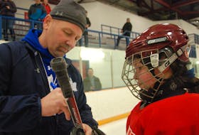 Katie Janes of Deer Lake gets her hockey stick autographed by Toronto Maple Leafs legend Wendel Clark during a Toronto Maple Leafs on-ice clinic Thursday at the Kinsmen Arena II in conjunction with 2018 Hockey Day in Canada.