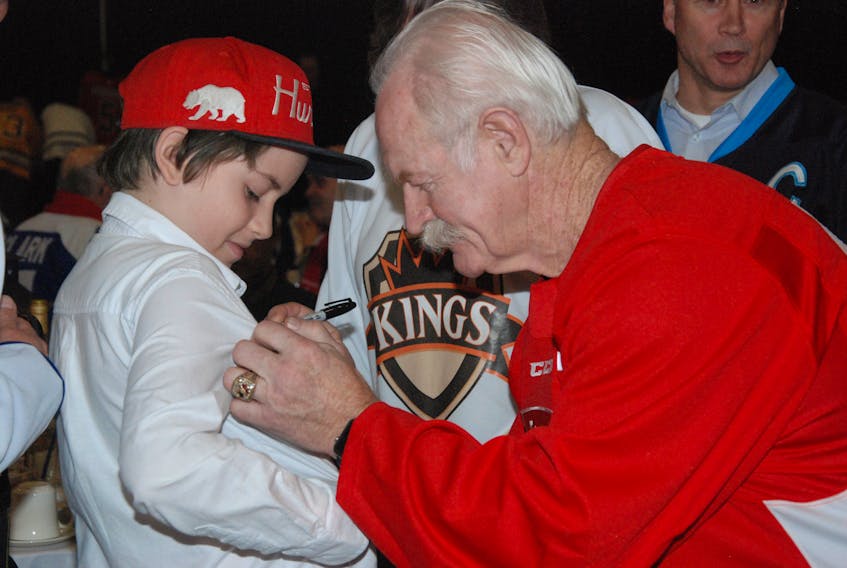 Zach Coley gets his shirt autographed by National Hockey League Hall of Famer Lanny McDonald during the gala on Thursday night.