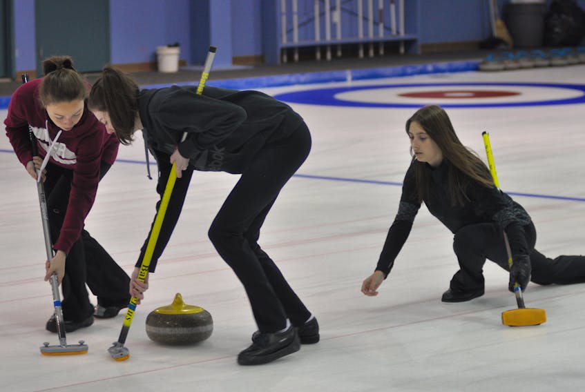 The Mackenzie Mitchell rink was - mostly - on the ice at the Corner Brook Curling Club on Thursday night, putting in some early preparations for the 2019 Canada Winter Games in Red Deer, Alta., where they will represent the province. Here, Mitchell (right) serves up a stone for sweepers Sarah McNeil Lamswood (left) and Mikayla O'Reilly. Teammate Ainsleigh Piercey was unable to attend the practice.