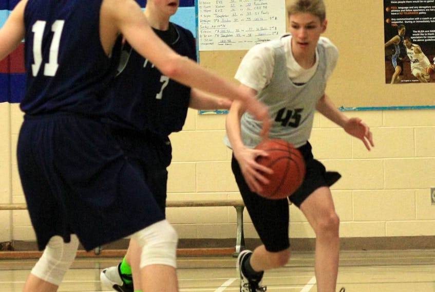Tournament MVP Keegan Piercey tries to make his way past two defenders with the Templeton Academy Tigers during the gold-medal game at the 2018 West Coast Provincial Grade 9 A Boys Basketball Tournament held in Meadows over the weekend. The home team had to settle for second spot after the Corner Brook squad eked out a 50-38 victory for the championship banner.