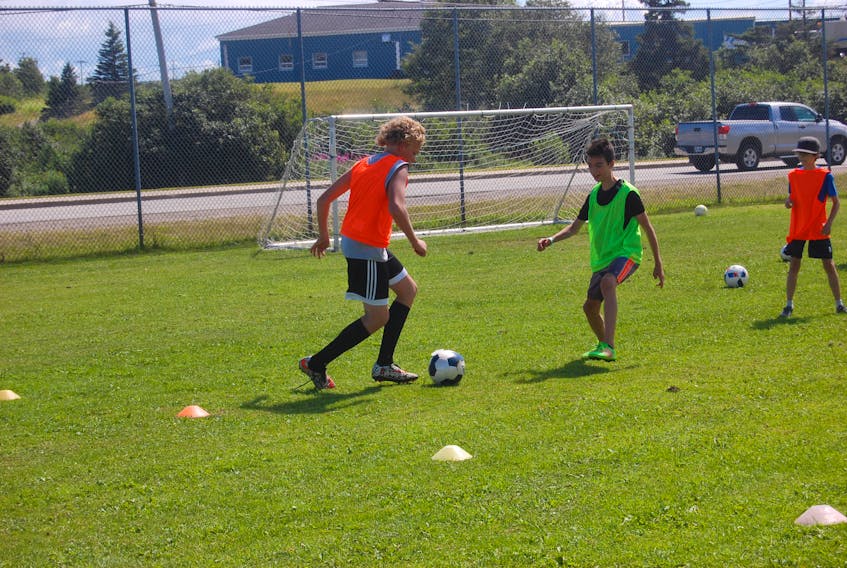 Clay King, left, of Stephenville Minor Soccer does some footwork as he attempts to get past Liam McIsaac with the ball during a practice drill at Mayfield Pitch in Stephenville in this file photo involving Under-12 and Under-14 boys' players. Seth Alexander is at the right.
