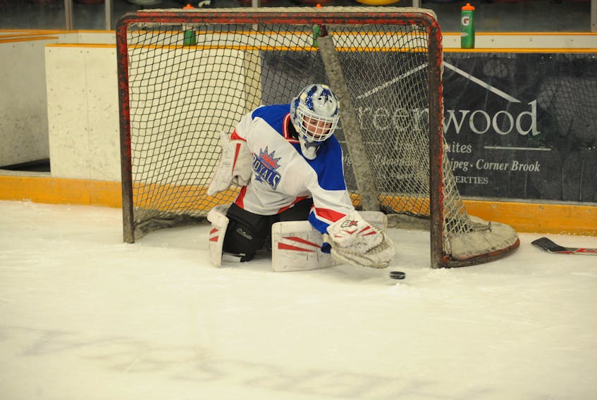 Goalie Josh Buckle moves to get his glove on a puck headed for the bottom corner of the net on Monday night at the Corner Brook Civic Centre as the peewee house league division wrapped up its season with a skills competition.