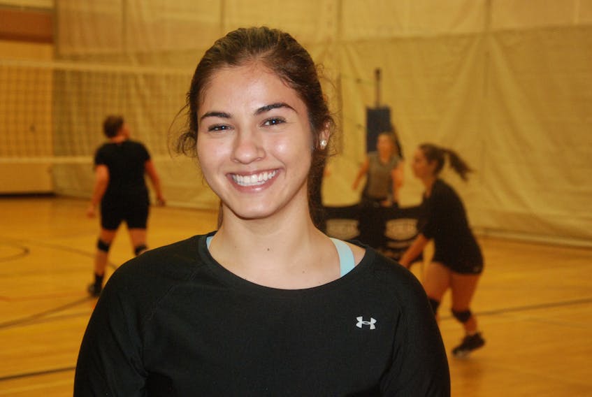 Sarah Melendez poses for a photo as volleyball practice goes on behind her on Tuesday evening at the Corner Brook Regional High gymnasium.