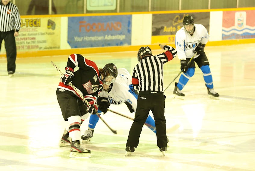 Mason Campbell of the Western Knights, left, battles Ethan Piercey of the Central Thunder in the face-off circle during the gold-medal showdown at the 2018 provincial minor midget hockey league championship Sunday at the Glovertown Arena. The Thunder eked out a 4-3 win in overtime to win gold.