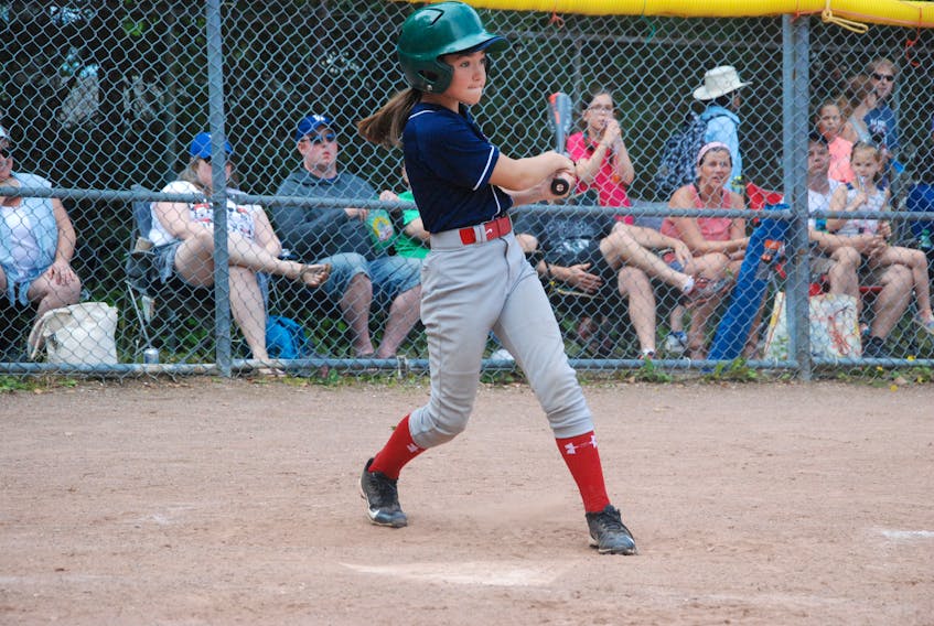 Sara Penney of the Corner Brook Barons follows through on her swing after making contact during a round-robin game against the St. John's Capitals in provincial 12U Girls AA baseball Saturday at Little Jubilee Field.