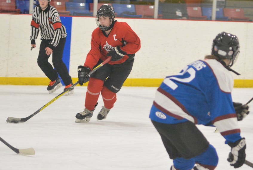 St. John's North forward Abby Newhook (left) makes a move on a Mount Pearl South defenceman during round robin play Thursday at the 2018 Newfoundland and Labrador Winter Games in Deer Lake.