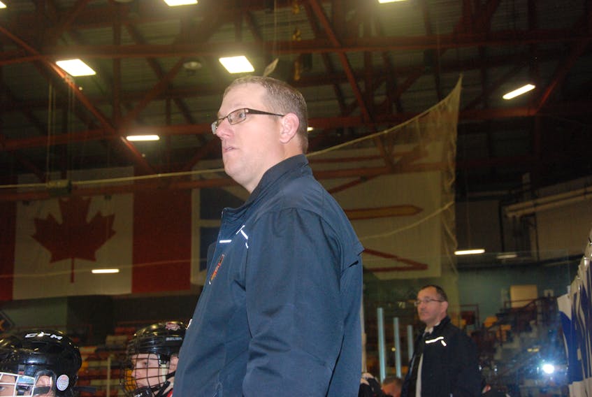 Western Kings coach Mark Robinson behind the bench during a provincial major midget hockey league game earlier this season.
