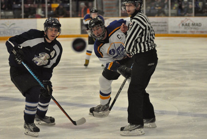 All eyes are on the puck after linesman Tony Baird of Corner Brook drops the it for a faceoff between Ryan Meade of the Corner Brook Royals, left, and Brad Lucas of the Stephenville Jets during a West Coast Senior Hockey League game during the inaugural campaign of the new league.