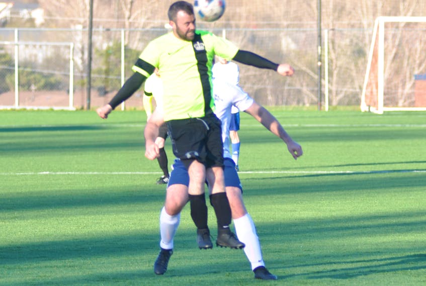 West Side Monarchs' Travis Cormier, front, leaps to get a head on the ball in front of Curling Rangers' Ryan Rose during Corner Brook Molson Senior Men's Soccer League play at Wellington Street Sports Complex on Wednesday evening. The game ended in a 1-1 draw.