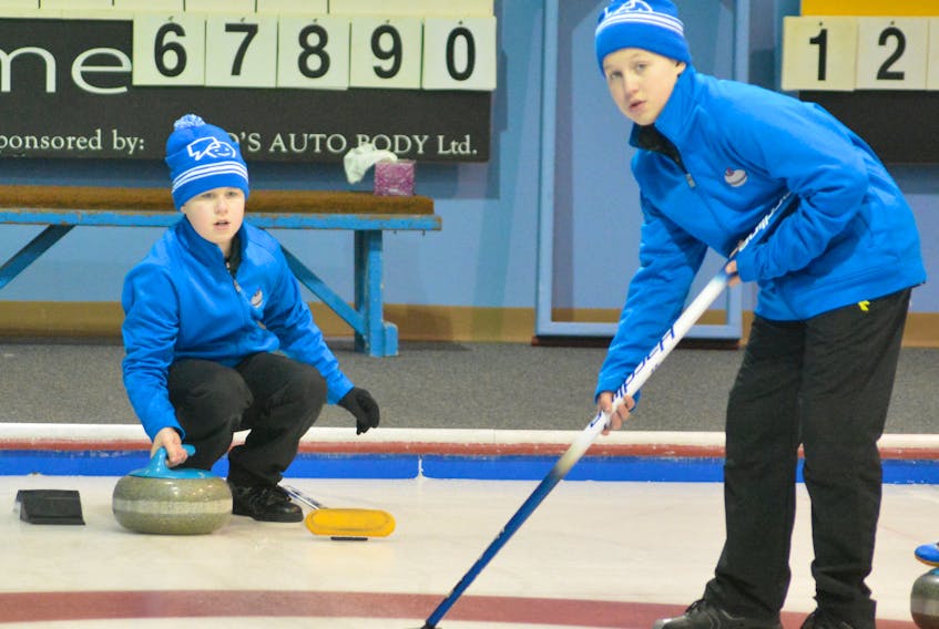 Spencer (left) and Parker Tipple get some shots in during warmups for the second day of curling competition at the Corner Brook Curling Club as a part of the 2018 NL Winter Games.