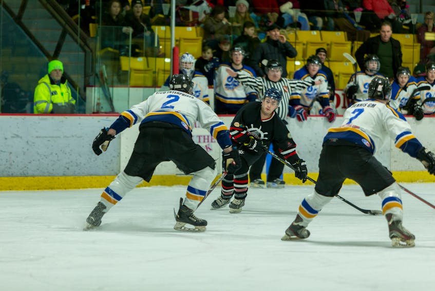 Port aux Basques Mariners’ Dylan Savory, centre, is watched closely by Stephenville Jets defenders Jeremy Drover, left, and Nathan Philpott during Friday night West Coast Senior Hockey League playoff action at the Stephenville Dome.