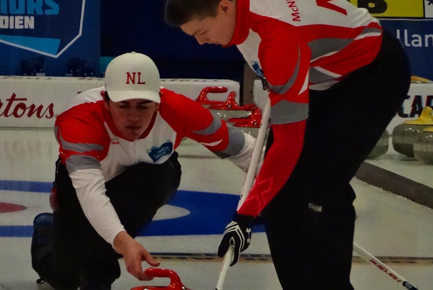 Nathan King of Corner Brook is seen here releasing a rock from the hack with Ryan McNeil-Lamswood sweeping during the 2018 national junior men’s curling championship in Shawinigan, Que.