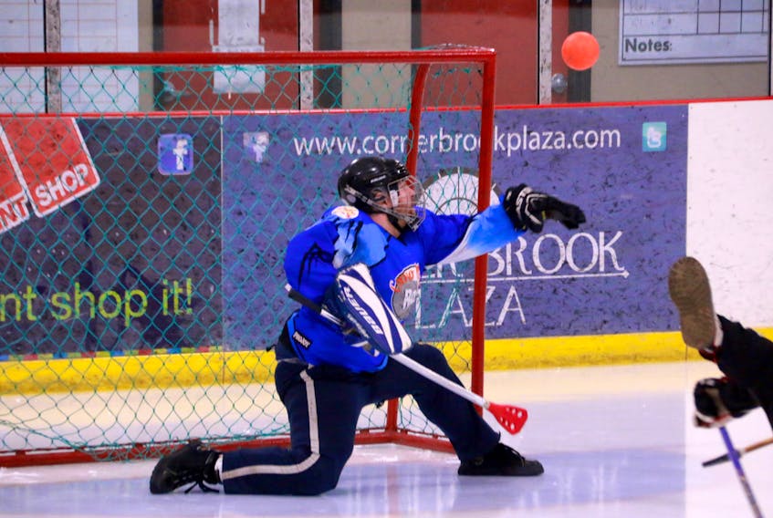 Marc Green, Corner Brook Rock goaltender, is able to bat the ball from the air to keep it out of the net.