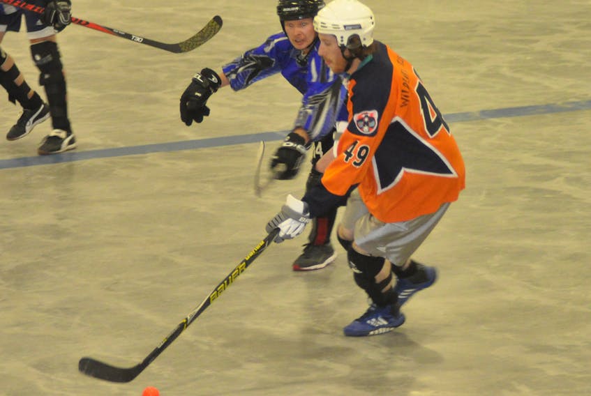 Luxury Limo Curling Rangers' Corey Russell, back, tries to stick check Gros Morne Wildlife Museum Gulls' John Walsh as he carries the ball during action in Game 3 of the Corner Brook Molson Men's Ball Hockey League final at the Kinsmen Arena II on Tuesday night.