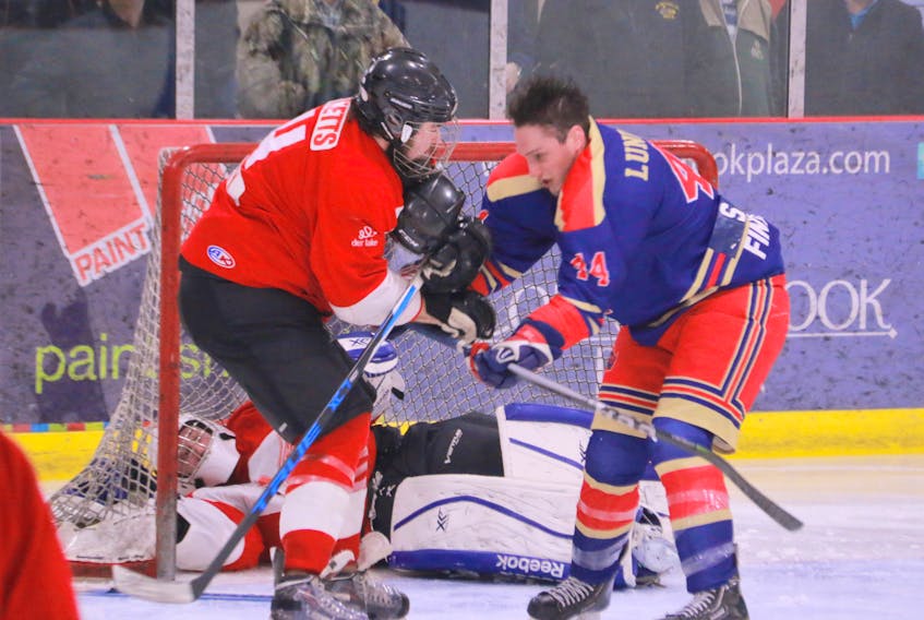 Deer Lake Red Wings' Michael Ricketts, left, and Corner Brook Royals' Matt Lundrigan battle in front of Red Wings goalie Ryan Hancock during Game 1 of the West Coast Senior Hockey League best-of-seven final at the Hodder Memorial Recreation Complex in Deer Lake on Friday night.