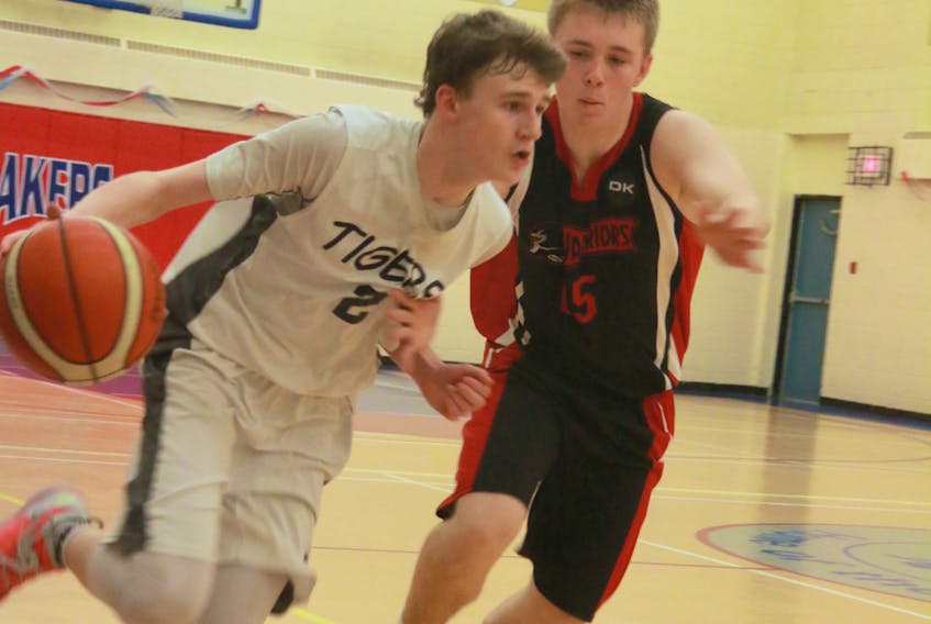 Templeton Academy Tigers' Kurtis White, left, dribbles around a Waterford Valley High Warriors defender during the Tier 1 championship game on Saturday.