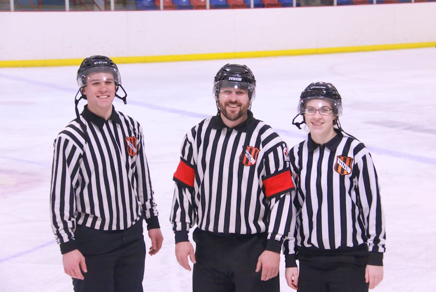 The Gillards were the third team on the ice for the male gold medal hockey game as the officials on Tuesday. Father Darren (middle) wore the stripes while his son Jalen (left) and daughter Jolena were on the lines.