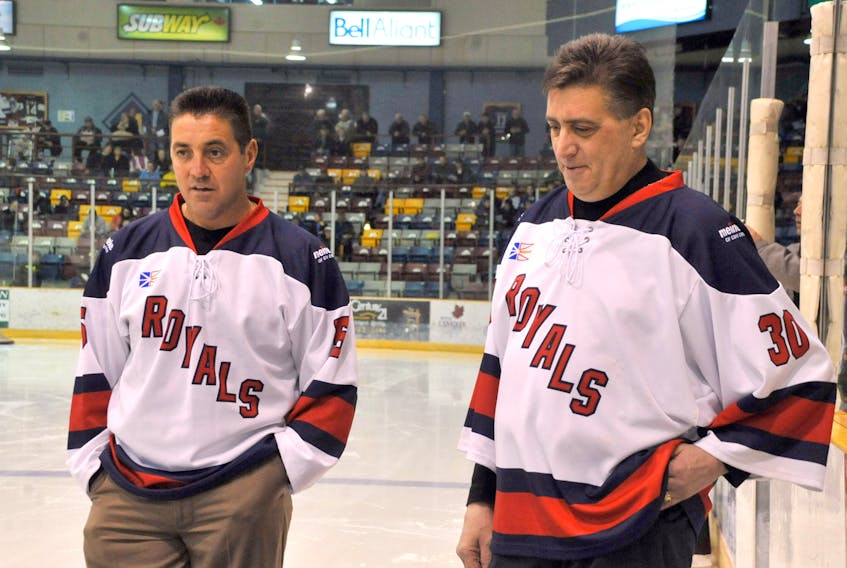 Dan Cormier, left, and teammate Dave Matte during their sweater retirement ceremonies for their contribution to the Corner Brook Royals.