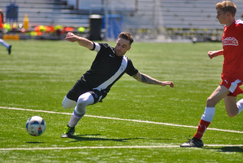 Flynn's Pub Tactics FC's Jeff Griffin was determined to keep the ball out of his team's end during the first half of play against the Ford Mustangs at the Wellington Street Complex in Corner Brook on Saturday.