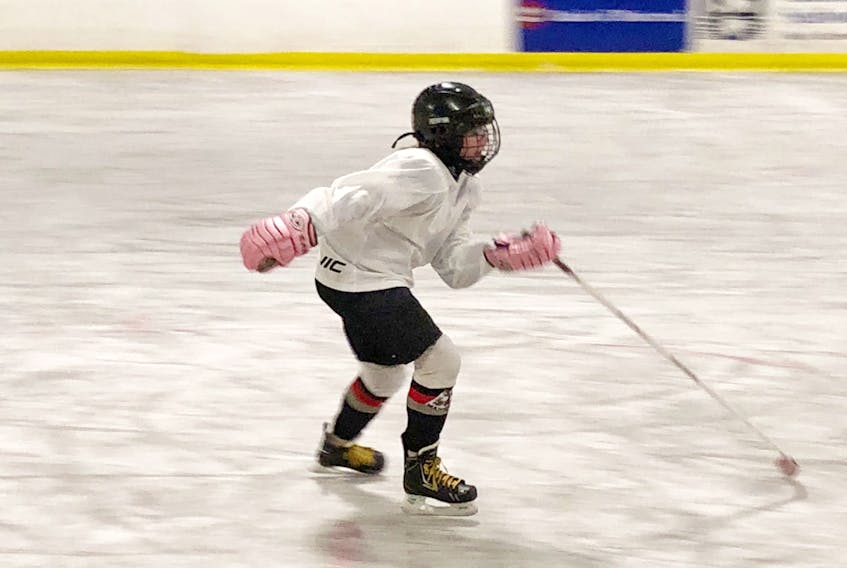 Savanna Payne glides up the ice at the Gros Morne Arena in Rocky Harbour. She is the only girl on the male peewee team but she insists she’s just another player who loves the game and has never been disrespected for the colour of her gloves.