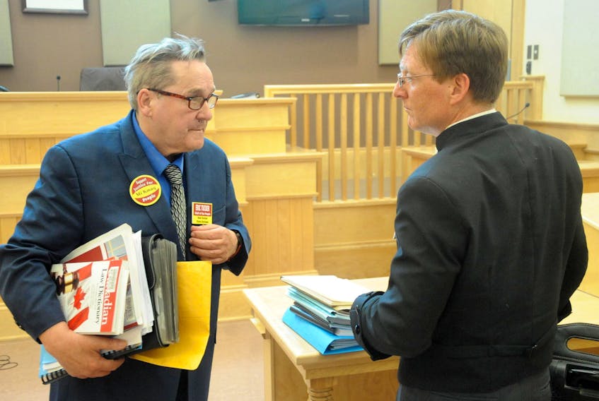 Eric Tucker, left, speaks with Jamie Merrigan, lawyer for the Federation of Newfoundland Indians and the Qalipu Mi’kmaq First Nation Band, following Tucker’s failed attempt to have the Supreme Court of Newfoundland and Labrador declare Merrigan to be in a conflict of interest for representing both entities.