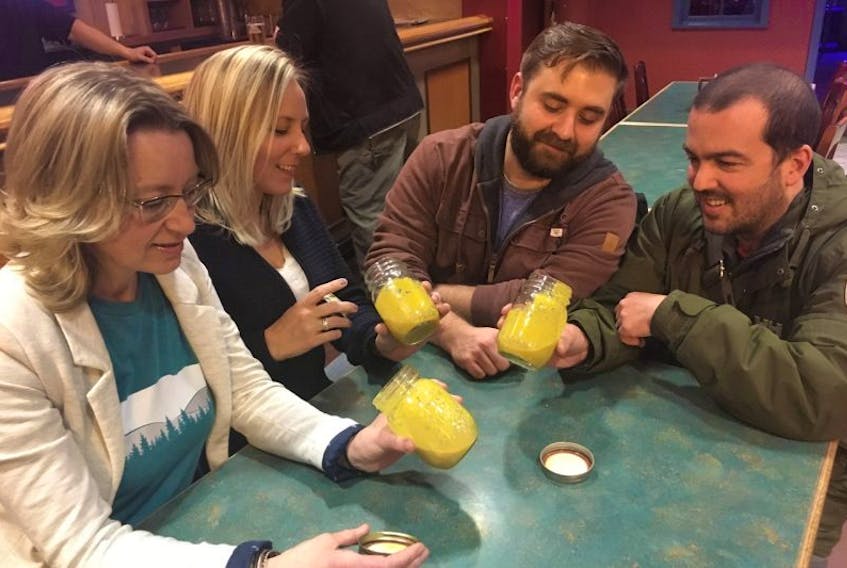 The team behind The Saucy Newfoundland Company, from left, Julia Allingham, Crystal McCall, Brad Small and Mark Tierney, check out a batch of their mustard pickle sauce.